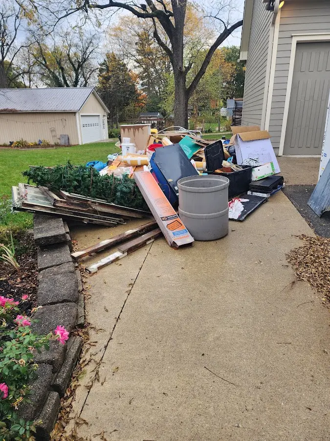 Dumpster being loaded with debris for 12 Yard Dumpster Rental in Ellenton